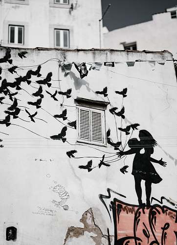 window man and woman kissing each other with flight of bird graffiti shutter